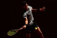 Felix Auger-Aliassime hits a forehand.